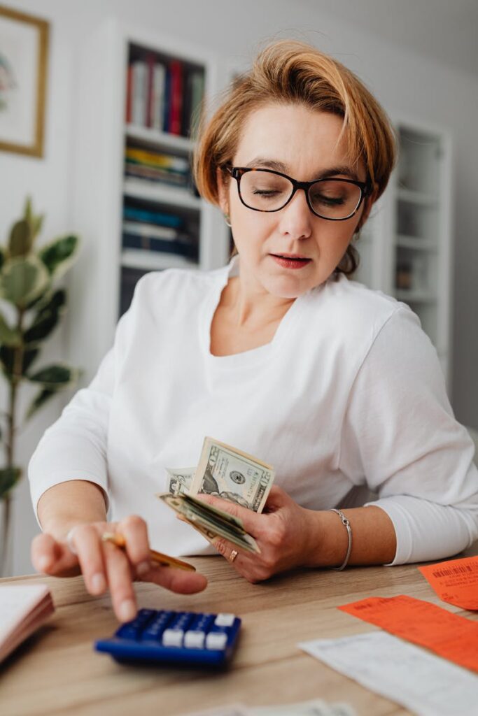 Frustrated woman using a loan calculator, struggling to find the right urgent loans for bad credit.